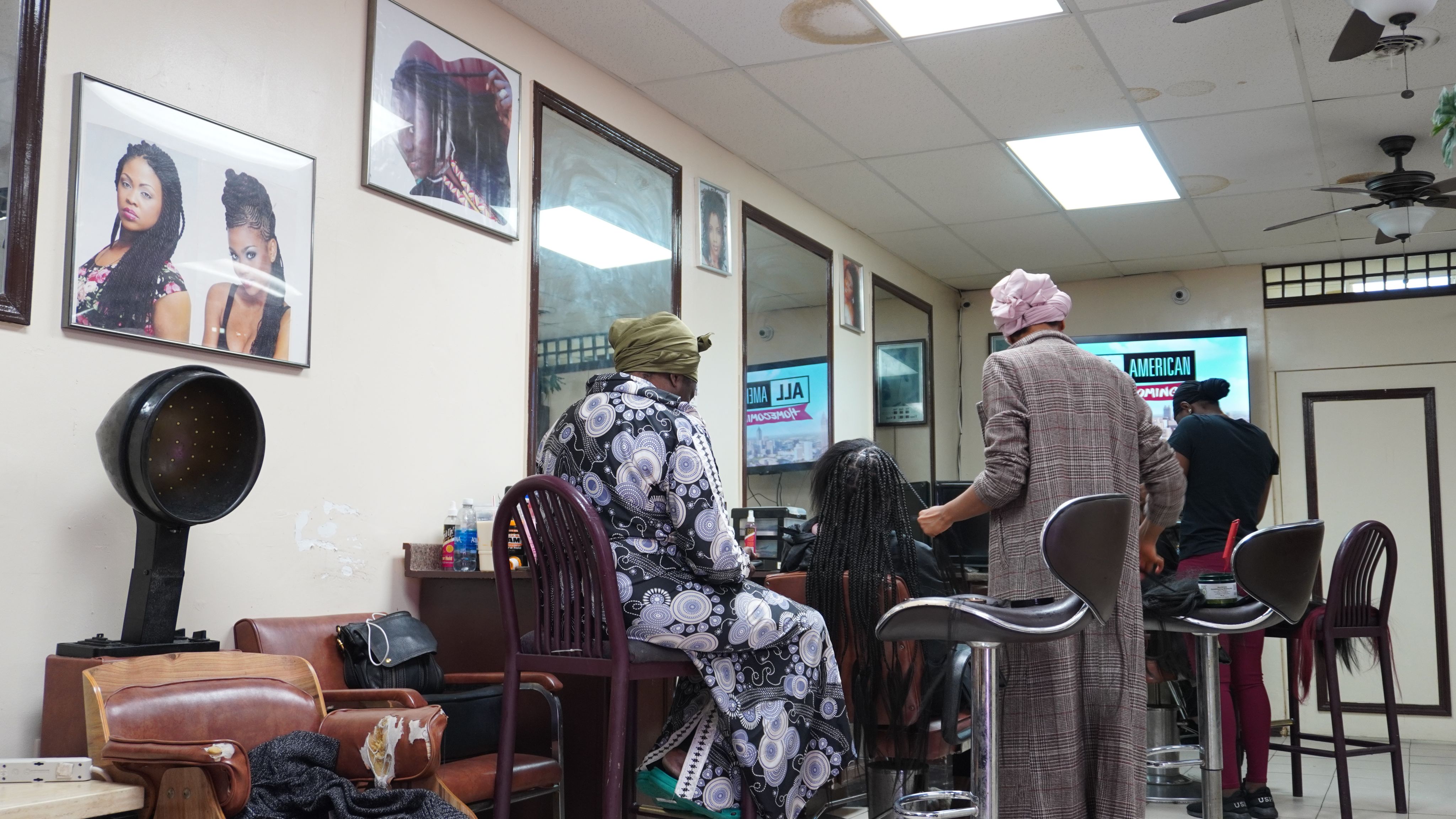 Owner and stylists working on a customer's hair